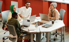People Working at Desk and Smiling